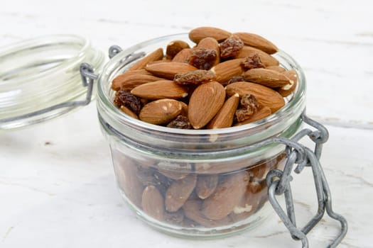 almonds with raisins dry in a glass jar