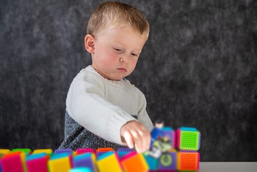 Portrait of cute little boy playing with a motorcycle toy