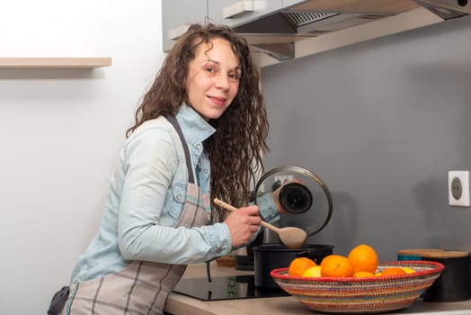 a young woman with long hair is in the kitchen