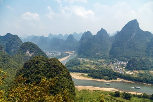 Picturesque mountains Yangshuo, Guilin, China with river and valley below