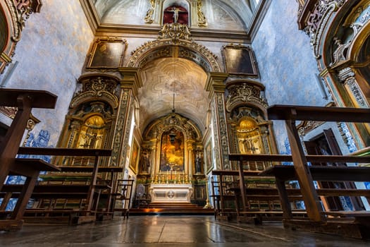View of the magnificent Baroque interior of the Church of Sao Pedro de Alcantara, built in 1681 in guilt woodwork with Franciscan iconography, in Lisbon, Portugal