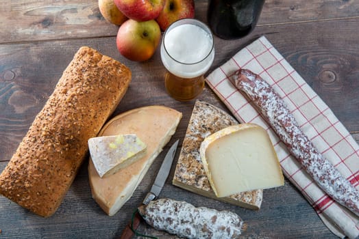 cheeses and Tomme de Savoie with beer, French cheese Savoy, the french Alps France.