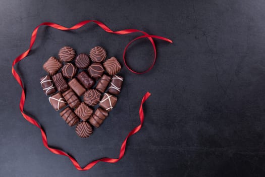 Chocolate pralines  for Valentines day or Mothers day concept on black background