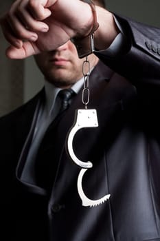 Freedom - businessman with unlocked handcuffs on hand