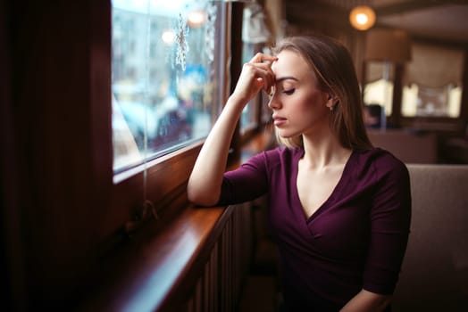 Beauty woman waiting in coffee shop. Young girl in restaurant.