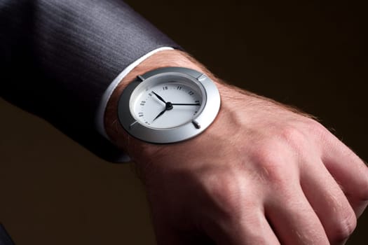 Business time - businessman looking to watch in hand
