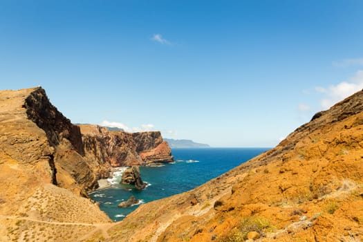 Summer ocean with rocky cliffs in sunny day