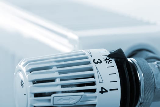 Closeup of heating radiator thermostat. Toned in blue