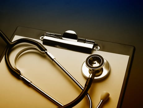 Clipboard with medical stethoscope. Toned