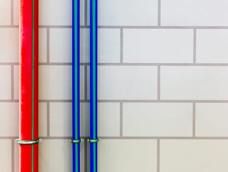 Red and blue water pipes on the wall