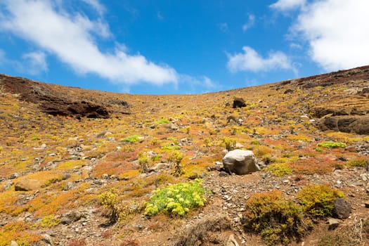 Rocky sandy hills against clear blue sky