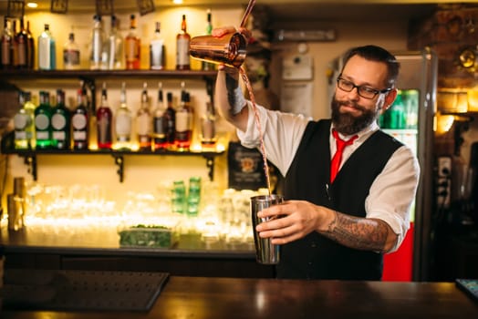 Barkeeper show behind restaurant bar counter. Handsome alcohol beverage preparation