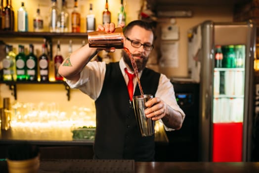 Barkeeper show behind restaurant bar counter. Handsome alcohol beverage preparation