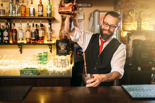 Barkeeper show behind restaurant bar counter. Handsome alcohol beverage preparation