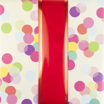 Big red ribbon on color gift paper