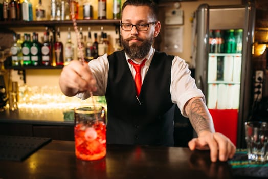 Attractive alcoholic drink preparation show. Professional bartending