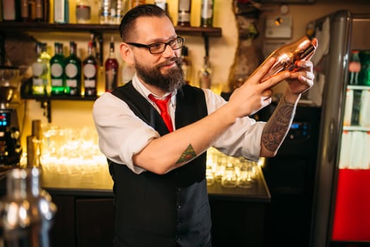 Bartender flair with shaker behind a bar counter. Barman flairing