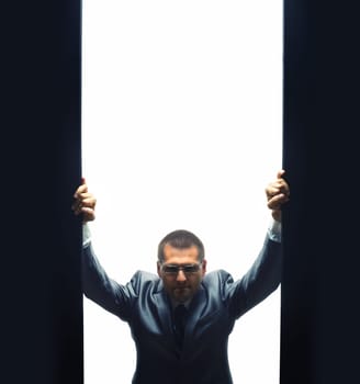 Coming confident businessman by opening some gate