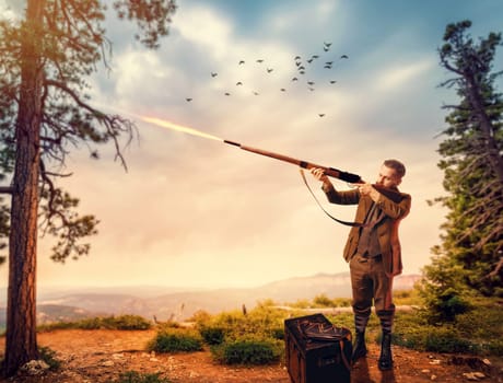 Duck hunter man in vintage hunting clothing aims an old rifle in forest. Hunt lifestyle, antique weapon