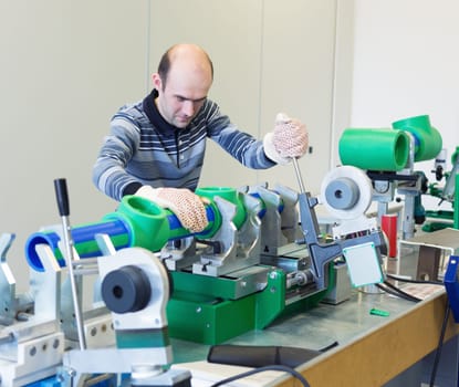 Mechanic working on a machine at workroom