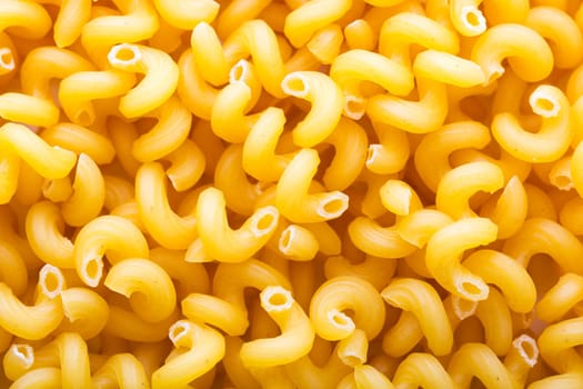 Heap of yellow macaroni closeup. Background
