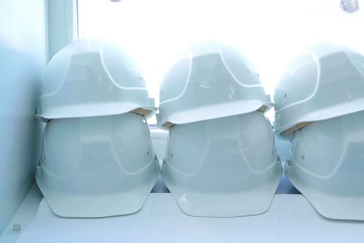 White helmets of workers lie on the windowsill. Protective helmet.