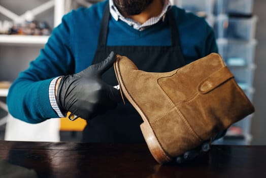 Shoemaker fix the shoe, footwear repair service. Craftsman skill, shoemaking workshop, master works with boots, cobbler job
