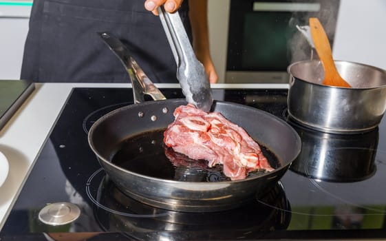 Raw meat on the frying pan