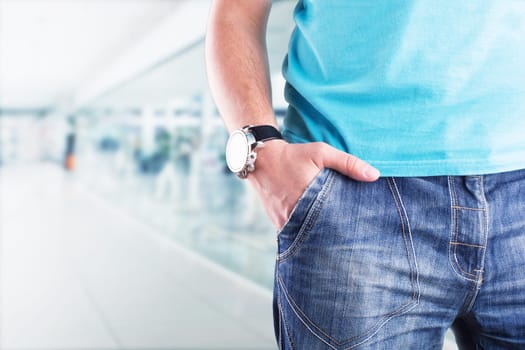 Closeup of a male standing with his hand in his pocket