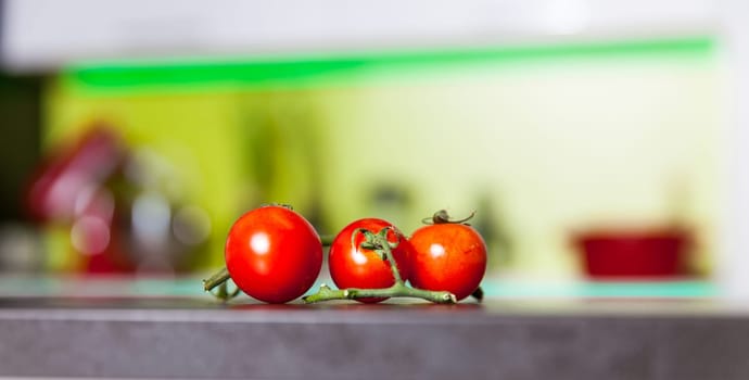 Branch of fresh red cherry tomatoes on the table