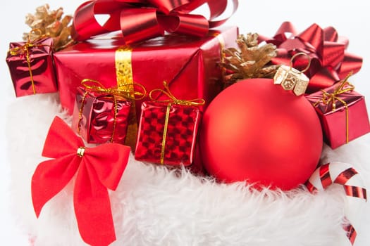Cute christmas present and decorative tree ball on white fur carpet