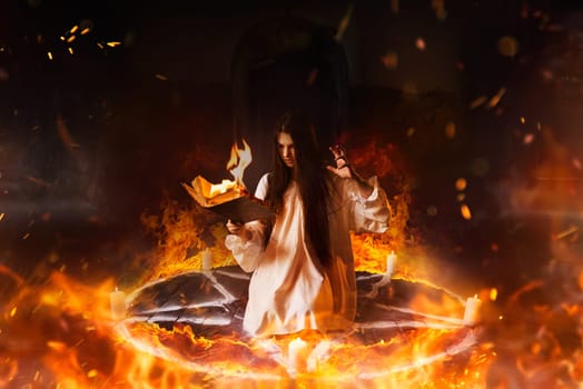 Young woman in white shirt sitting in the center of burning pentagram circle and reads spellbook, gark magic ritual, mysticism