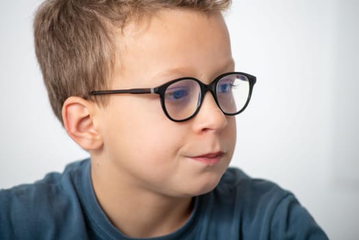 a portrait of a pensive boy with glasses
