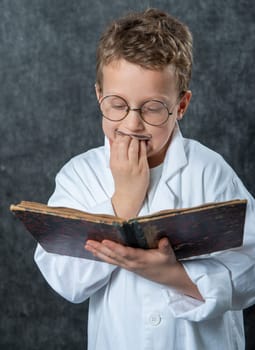 cheerful boy retro with a white blouse reading a old book