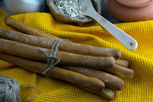 Women's hands mix the dough on a wooden table. Preparing bread for baking. Front views