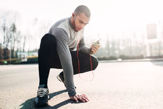 Athlete before running, active, healthy lifestyle. Jogger on morning fitness workout. Runner in sportswear on training outdoor