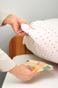 Woman hides money under pillow