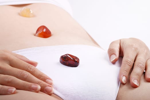 Alternative medicine - healing by semiprecious gems placed on body chakras, shallow depth of field