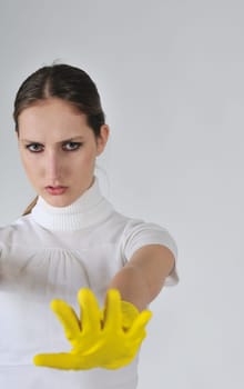 Young woman stretching hands with yellow gloves on