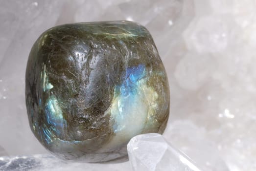 Labradorite gem energized on druze of quartz crystals. This gem is used as a jewel stone and also in alternative medicine and esoterics (it is used for strenghting aura).