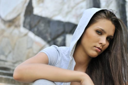 Young person (teenage girl) portrait in hip hop style siting on stairs