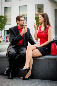 Together on icecream - young business people having great time in street