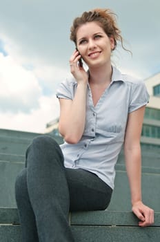 Young beautiful smiling woman calling with mobile phone