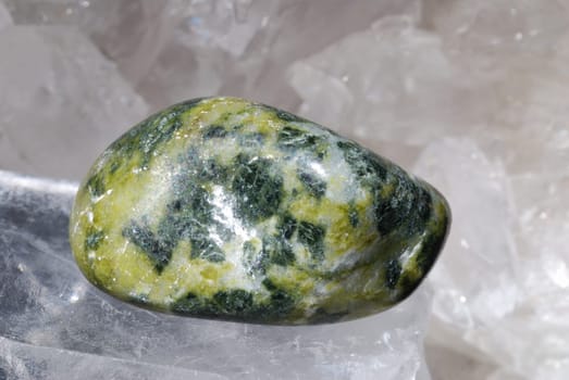 Nephrite gem energized on druze of quartz crystals. This gem is used as a jewel stone and also in alternative medicine and esoterics (connected with heart chakra).