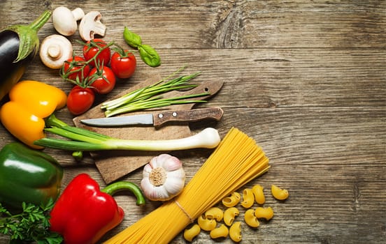 Pasta with Vegetables ingredients on old wooden table