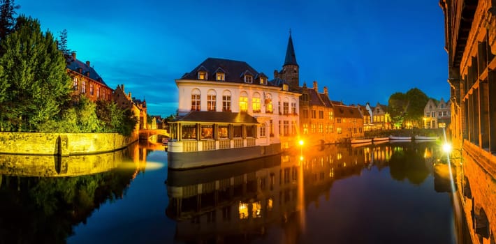 Belgium, Brugge, old European town with buildings on river, night view. Tourism and travels, famous europe landmark, popular places