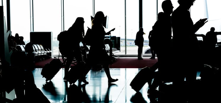 People with luggage go to registration in airport. Travel or tourism concept.