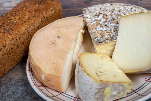 bread, cheeses and Tomme de Savoie, French cheese Savoy, french Alps France.