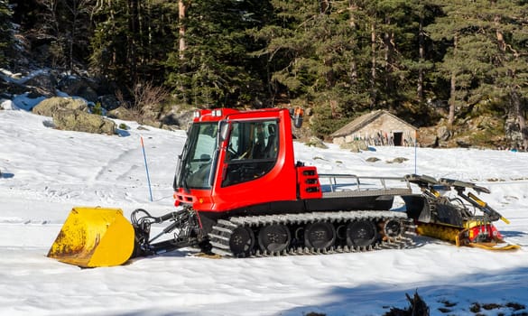 view of a red snow groomer