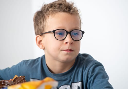 a portrait of a pensive boy with glasses